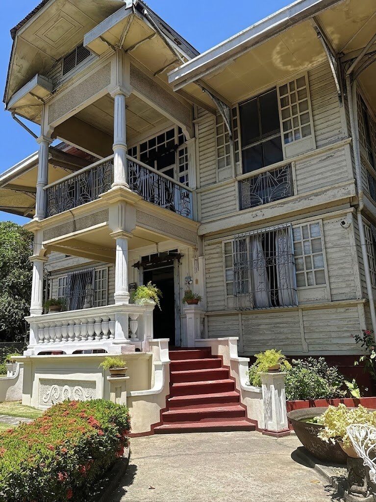 Silay Heritage House Negros Occidental Filipino-Spanish colonial mansion with white wooden balustrades, capiz windows, and red staircase