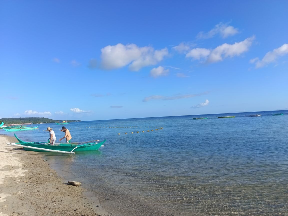 Laiya Beach Batangas tranquil shoreline with turquoise water and tropical green hillside representing one of Batangas top beach destinations