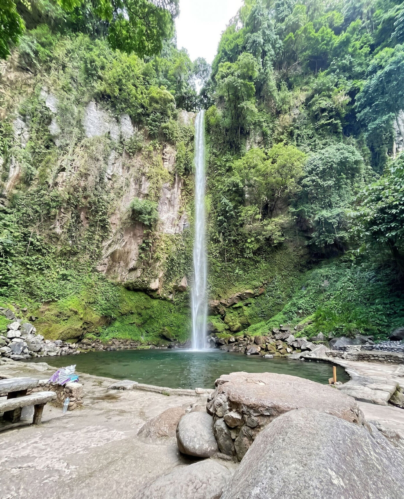 Katibawasan Falls Camiguin 76-meter waterfall cascading down lush jungle cliff into natural pool