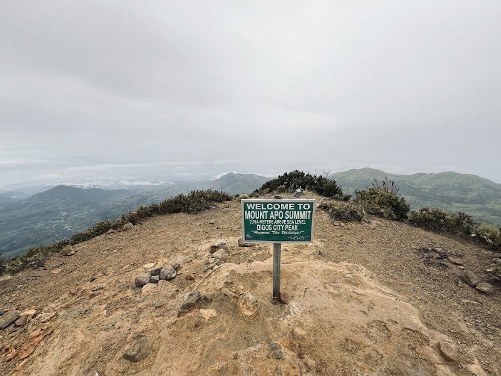 Mount Apo summit sign at 2,954 meters above sea level with panoramic mountain views in Davao Philippines