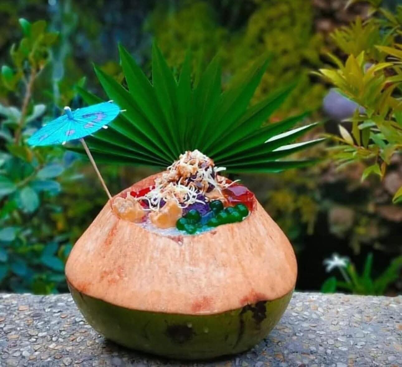 Halo-Halo de Iloko famous La Union dessert served in a coconut shell with colorful jelly and ube ice cream