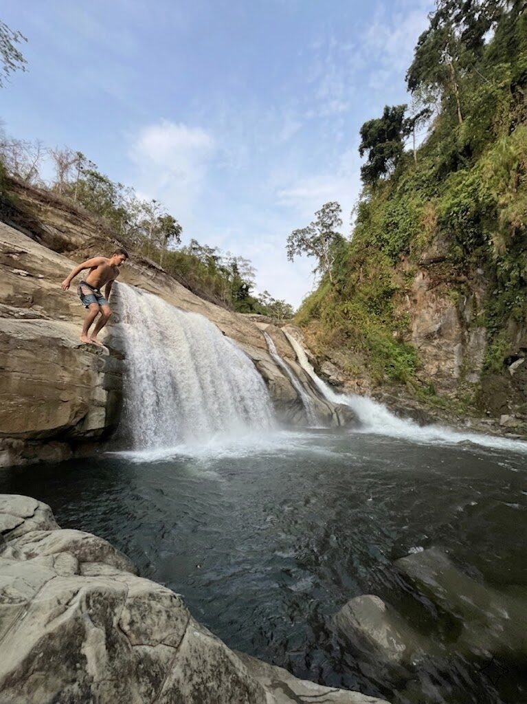 Tangadan Falls La Union waterfall flowing into natural deep pool with cliff jumping platform in San Gabriel