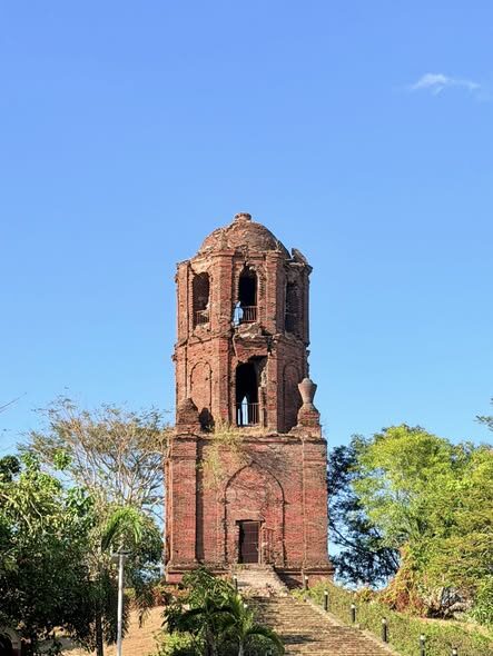 Bantay Bell Tower Vigan ancient red-brick Spanish colonial bell tower against clear blue sky