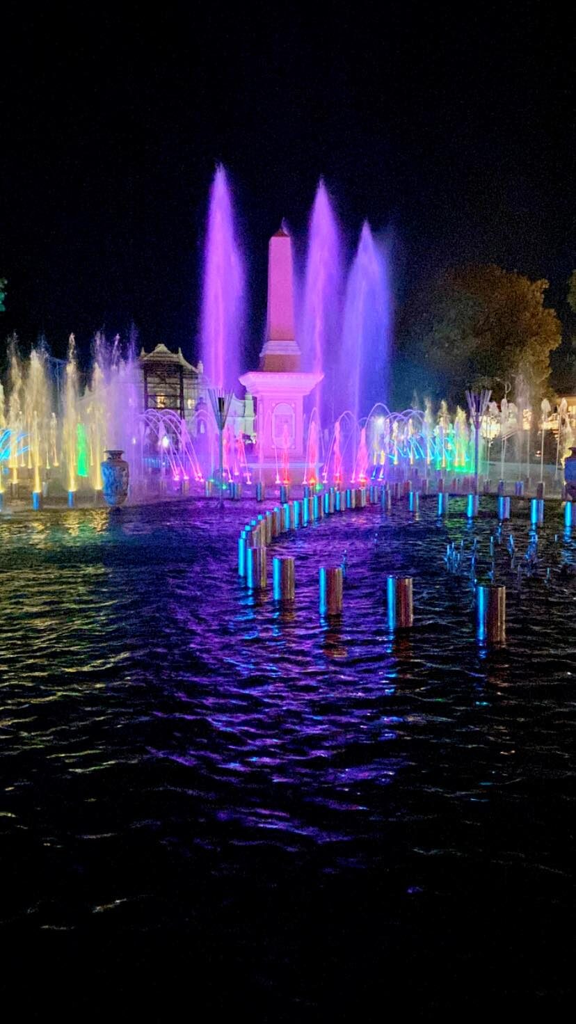 Plaza Salcedo Vigan dancing fountain show at night with colorful purple and blue illuminated water jets